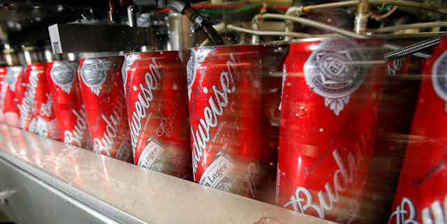 Budweiser cans on a factory line.