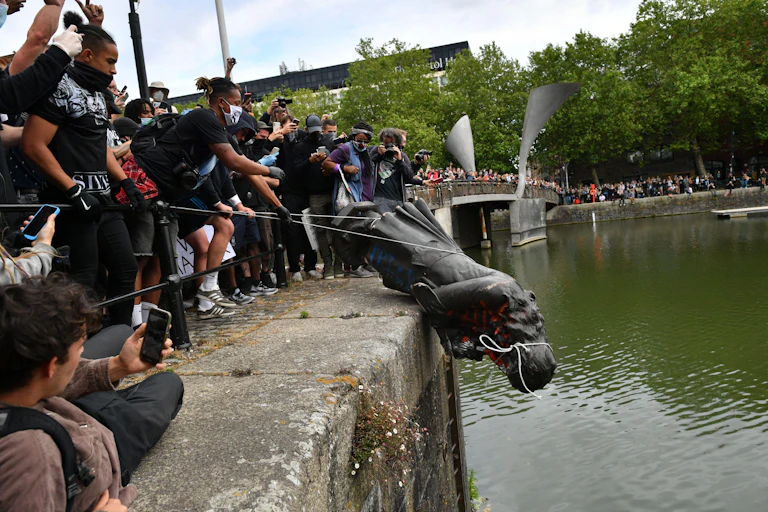 Group of protesters push Edward Colston statue into Bristol harbour during 2020 Black Lives Matter protests