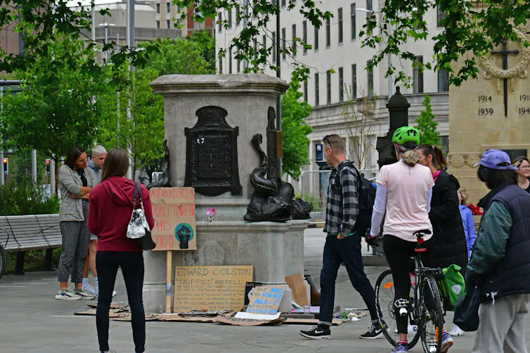 Crowd gathers in front of empty plinth where Bristol's Edward Colston statue once stood
