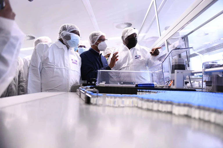 Men in PPE standing in a laboratory