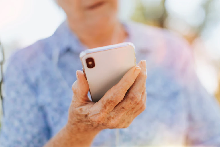 Smartphone held in woman's hand.