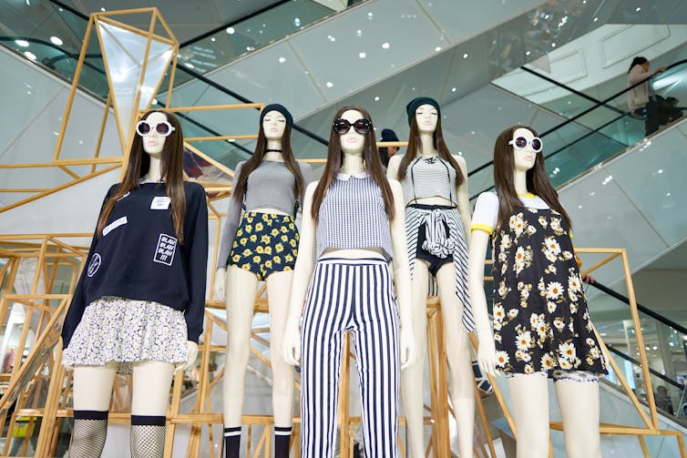 Five mannequins in fashionable clothing