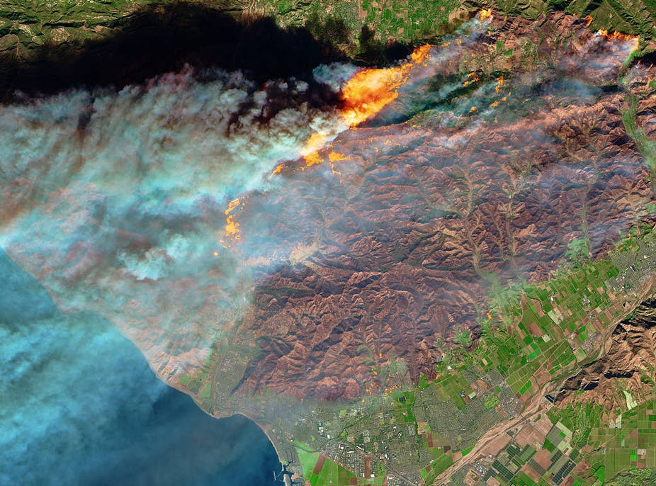 Satellite image of fire, mountains and a town