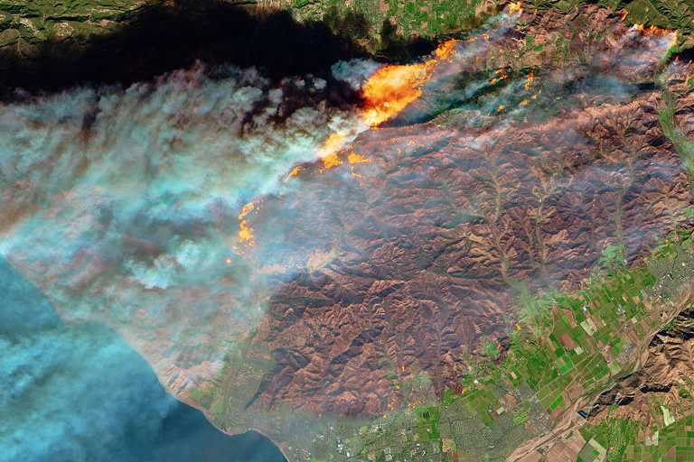 Satellite image of fire, mountains and a town