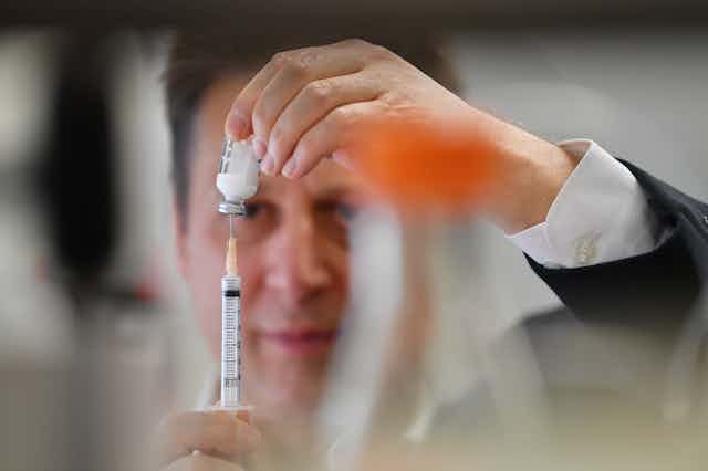 Professor Nikolai Petrovsky with Vaxine's COVID vaccine candidate