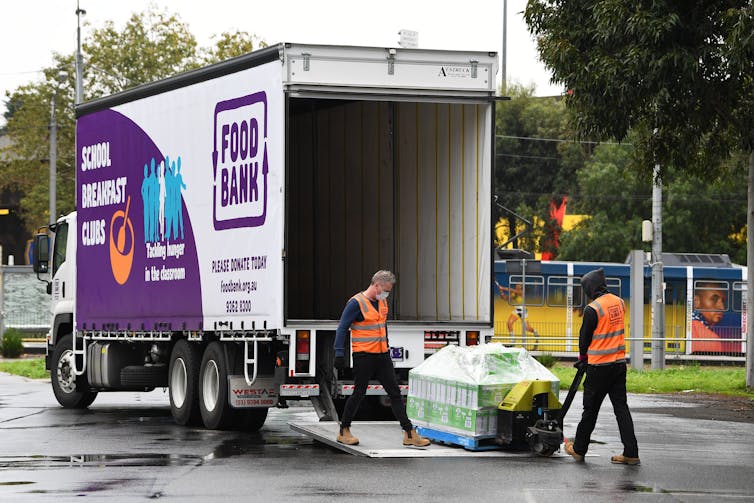 Food Bank workers unloading food aid off truck