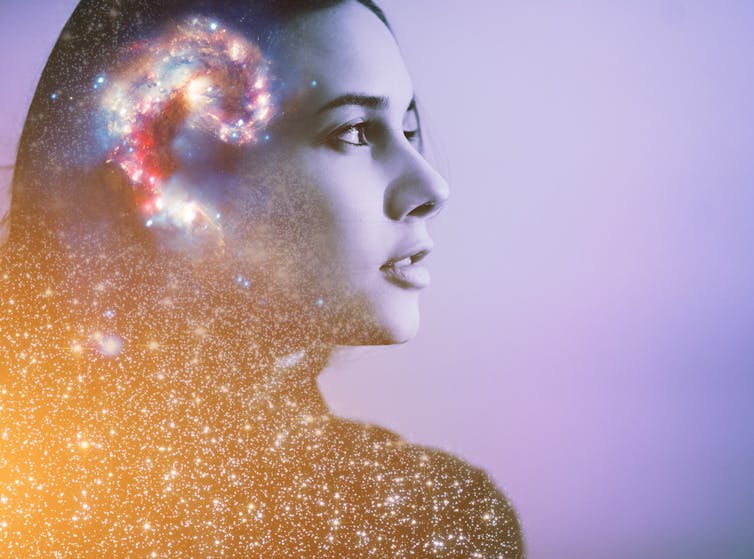 A portrait of a woman with a drawing of a galaxy over her brain.