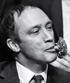 Pierre Trudeau with a carnation in his mouth.