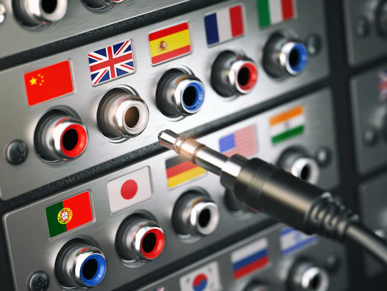 An audio input output/control panel with flags over each plug