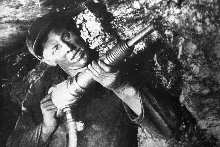 Man drilling in coal mine.