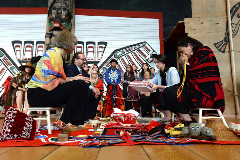 People sit in a circle, preparing a final report