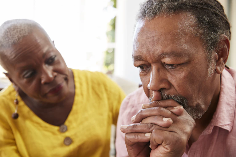 Older woman comforting older man.