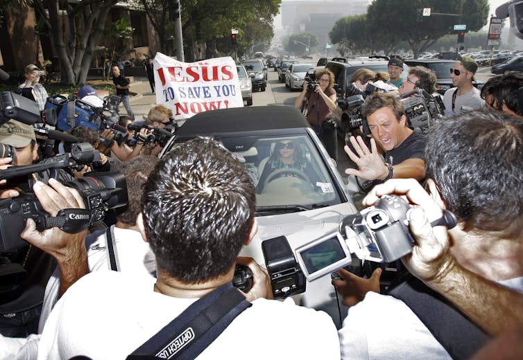 Paparazzi swarm Britney Spears' car.