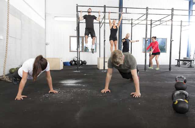 People workout at a gym.
