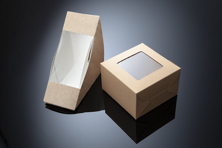 Two small cardboard boxes with plastic film inside them.