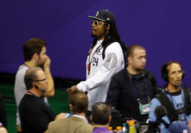Seattle Seahaws running back Marshawn Lynch leaving a press conference before the 2015 Super Bowl.