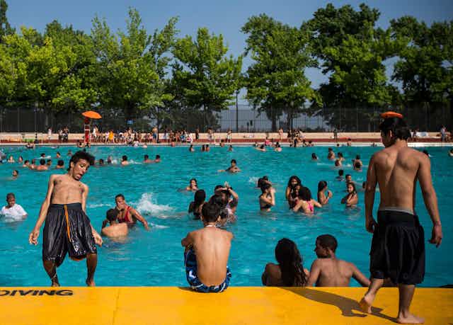 Children play in a public pool.