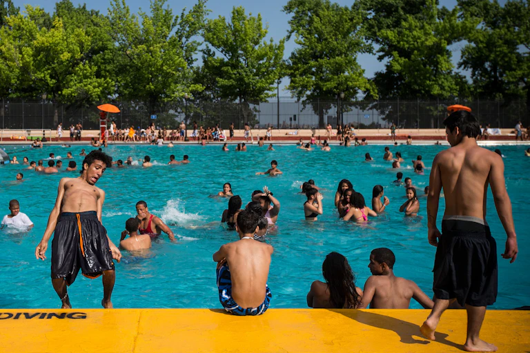 Children play in a public pool.