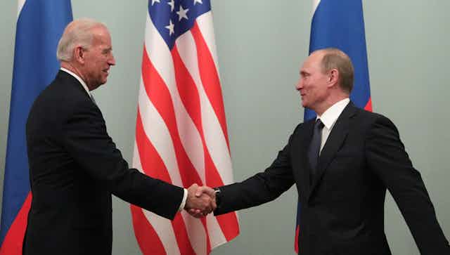 Joe Biden and Vladimir Putin shake hands during the then US vice president's 2011 trip to Moscow.