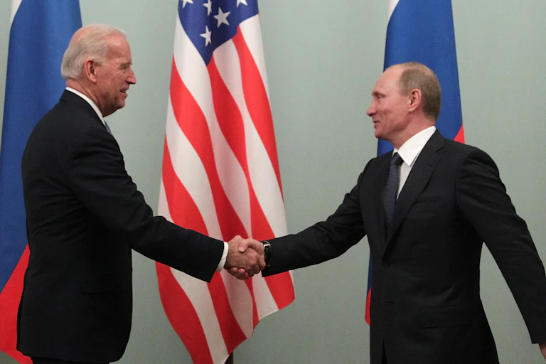 Joe Biden and Vladimir Putin shake hands during the then US vice president's 2011 trip to Moscow.
