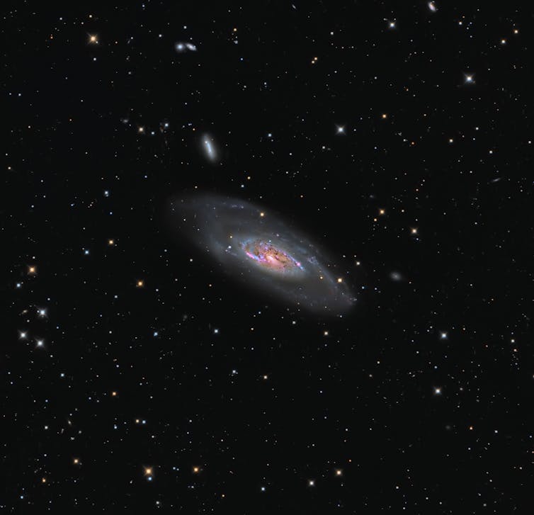 An image showing detail of one galaxy, but visually implying there are many more.