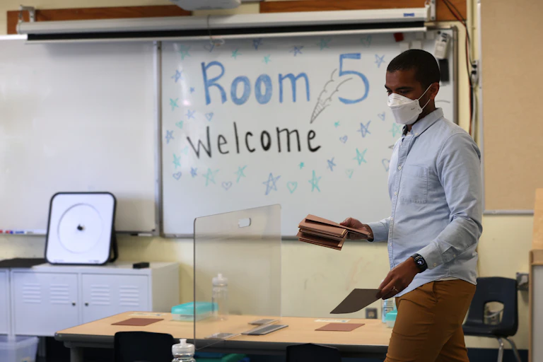 Teacher prepares his classroom before students arrive