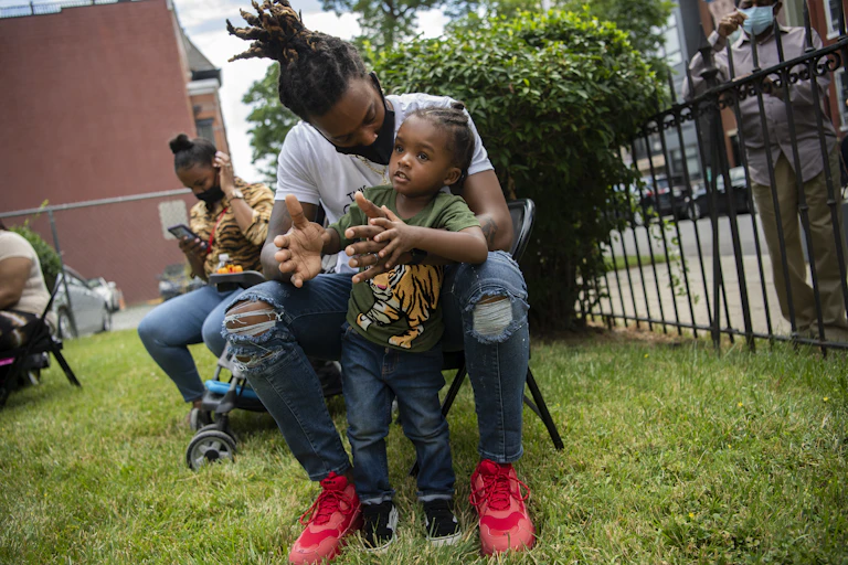 Father holding and talking to young child