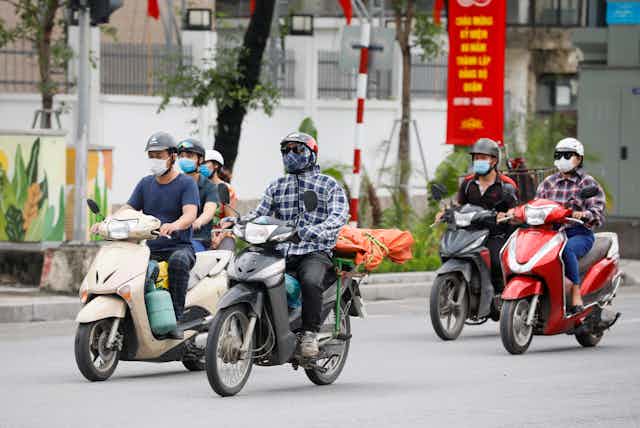 People riding motorbikes in Vietnam.