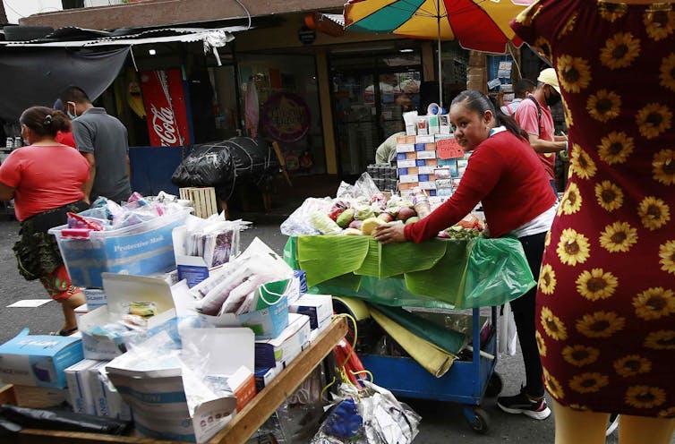 A street market in San Salvador, the capital of El Salvador. It's questionable that buyers and sellers of most good and services will want to use Bitcoin.