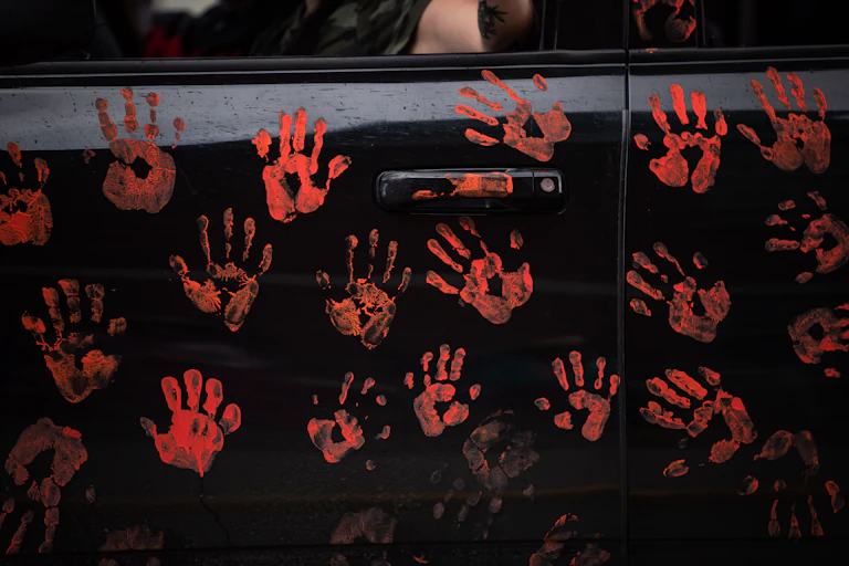 Handprints representing 215 Indigenous childrenare seen on the side of a truck.