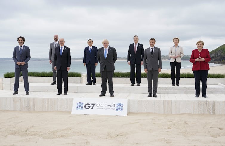 Leaders of the seven current nations in the G7 as well as of the European Commission and European Council stand and pose for a picture in Cornwall, England