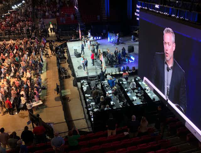 J.D. Greear, president of the Southern Baptist Convention, is shown on a video screen addressing the denomination's annual meeting in Birmingham, Alabama in 2019.