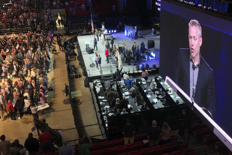 J.D. Greear, president of the Southern Baptist Convention, is shown on a video screen addressing the denomination's annual meeting in Birmingham, Alabama in 2019.