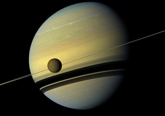 Titan in front of Saturn