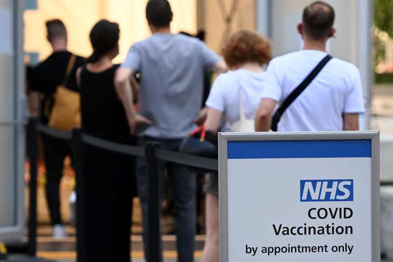 People queuing outside a UK vaccination centre