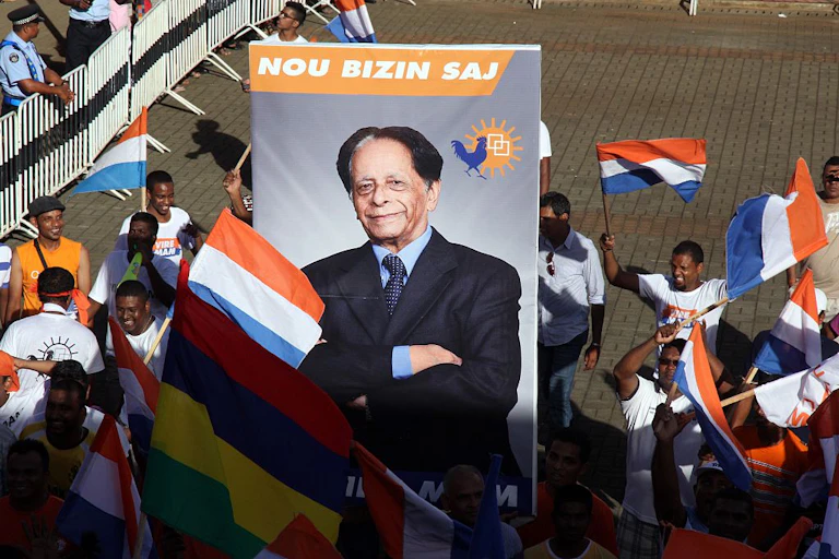 Supporters of Anerood Jugnauth carry a poster with his image