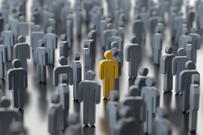 A yellow human figure surrounded by grey figures