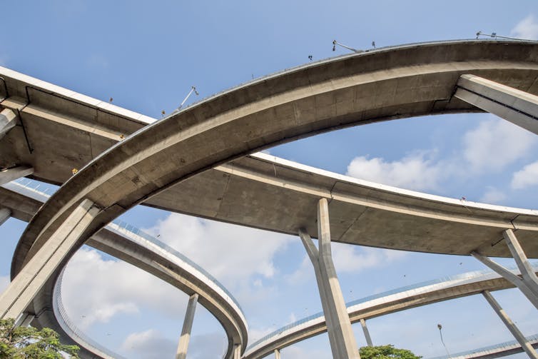 Looking up at a tangle of highway overpasses.