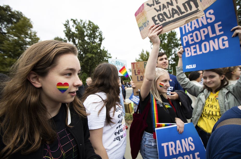Students holding banners supporting equality for LGBTQ people on Oct. 8, 2019, in Washington D.C.