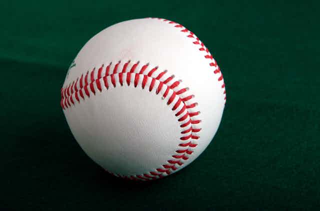A baseball against a green background