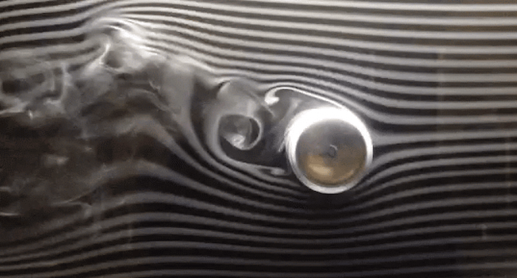 A spinning cylinder with smoke helping to visualize the uneven air currents.