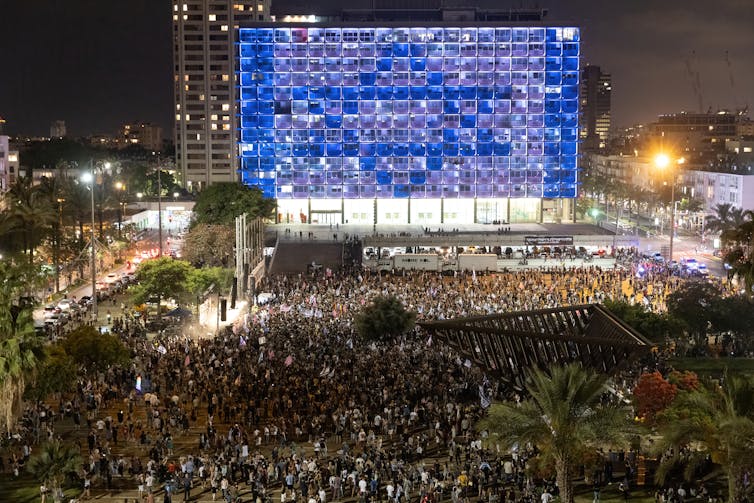 Miles de personas bailando en una plaza pública en Tel Aviv, Israel.