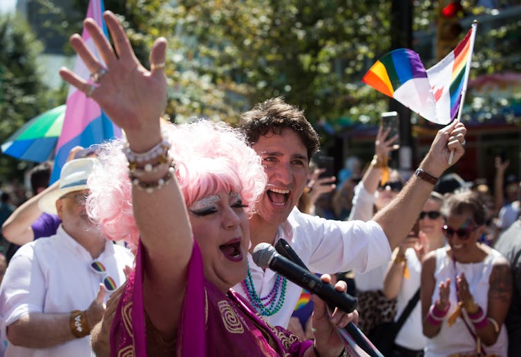 Justin Trudeau stands behind a drag queen during a Pride parade