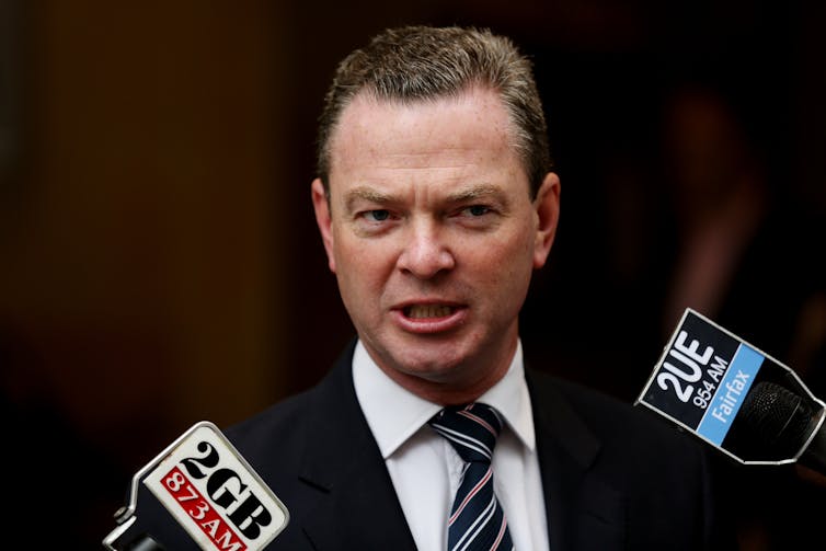 Man in suit speaking at a press conference