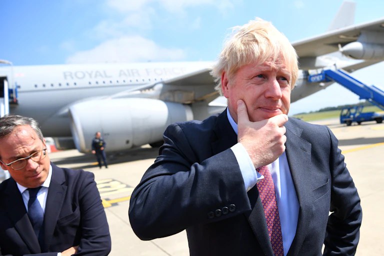 Scruffy man contemplates plane