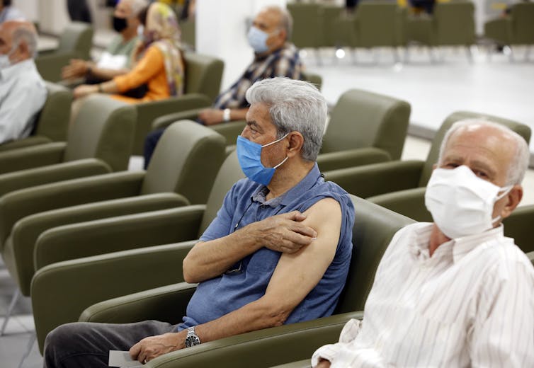 Older Iranian people waiting to be vaccinated.