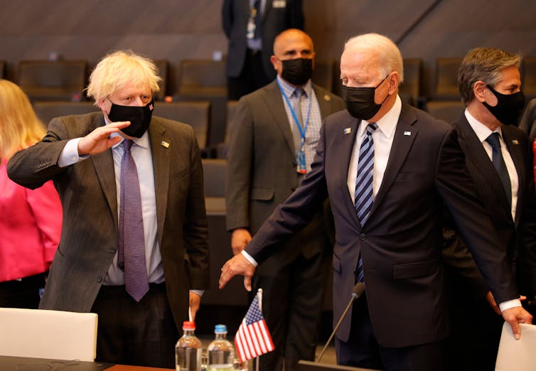 Boris Johnson and Joe Biden, both wearing masks, at the Nato summit in Brussels, June 2021.
