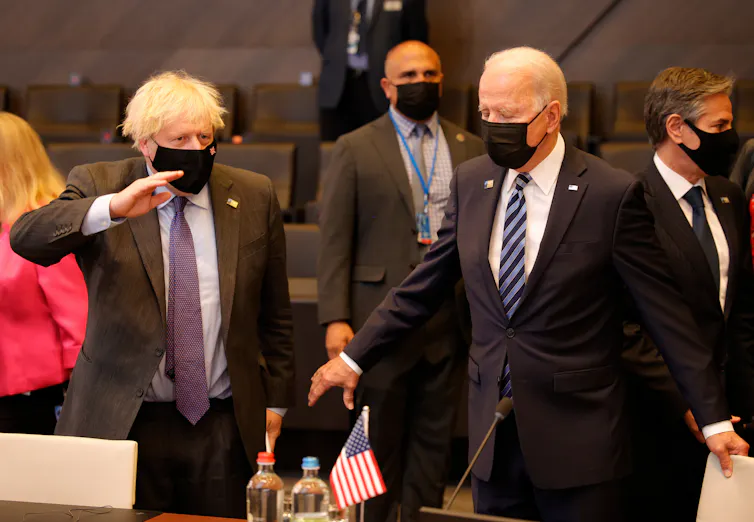 Boris Johnson and Joe Biden, both wearing masks, at the Nato summit in Brussels, June 2021.