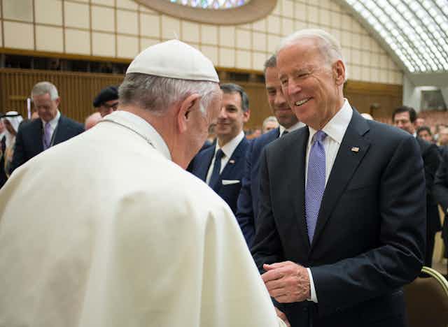 Pope Francis shakes hands with then US vice president Joe Biden in 2016.