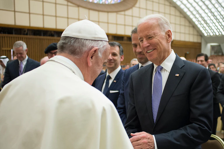 Pope Francis shakes hands with then US vice president Joe Biden in 2016.